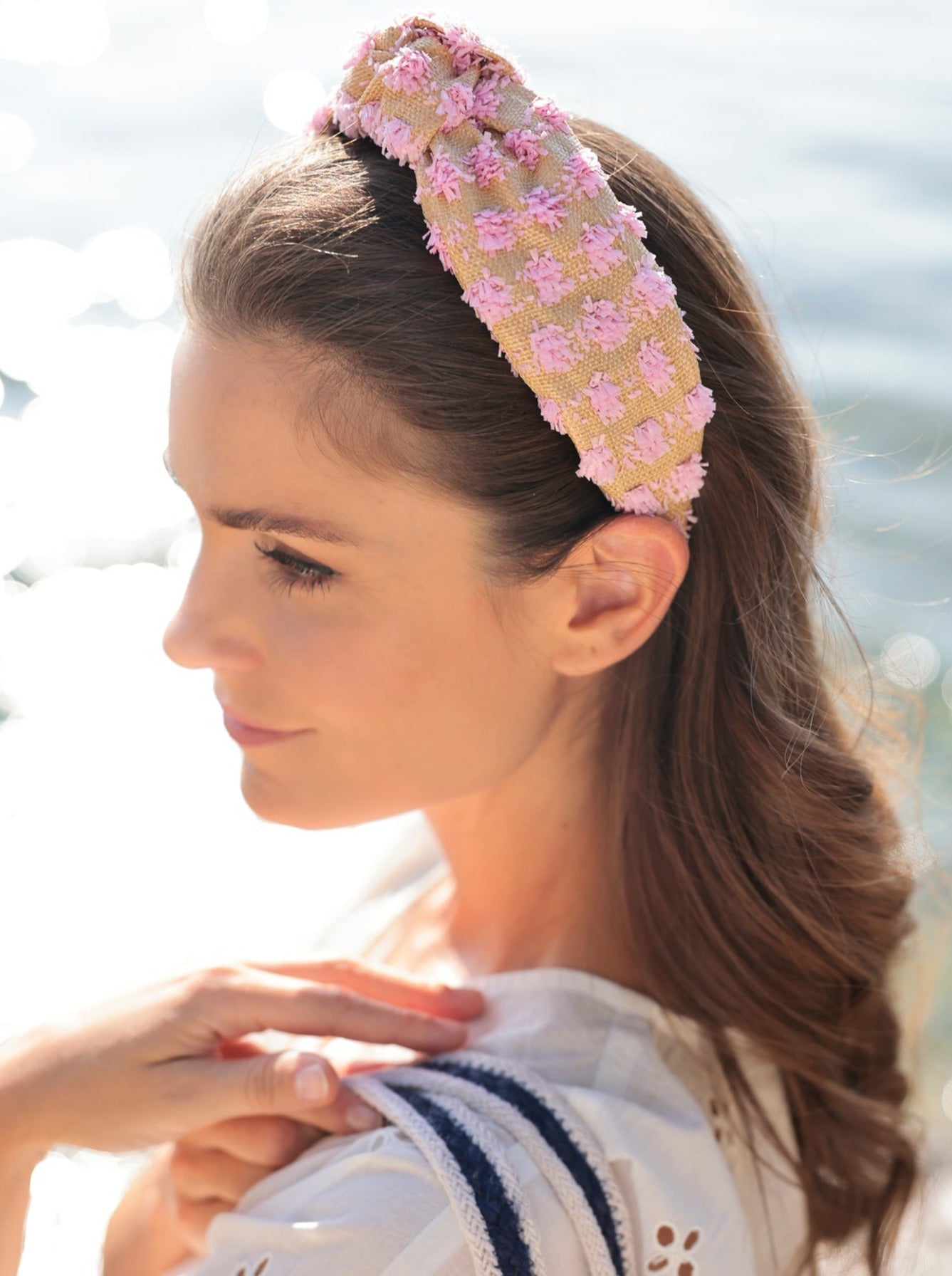 Add an elevated touch to your summer hairstyles with Shiraleah's Tufted Straw Knotted Headband. With its tufted fabric and top knot detail, this chic and trendy headband will be your new favorite summer accessory. Pair with other items from Shiraleah to complete your look!
